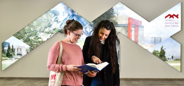 Two Women Looking at a Book